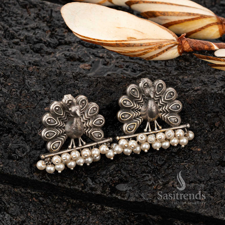 Peacock-themed oxidised earrings with dangling pearl accents - Sasitrends