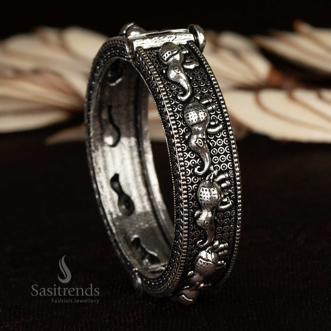 A screw-type openable oxidized kada bangle with intricate ethnic floral designs, perfect for traditional wear - Sasitrends