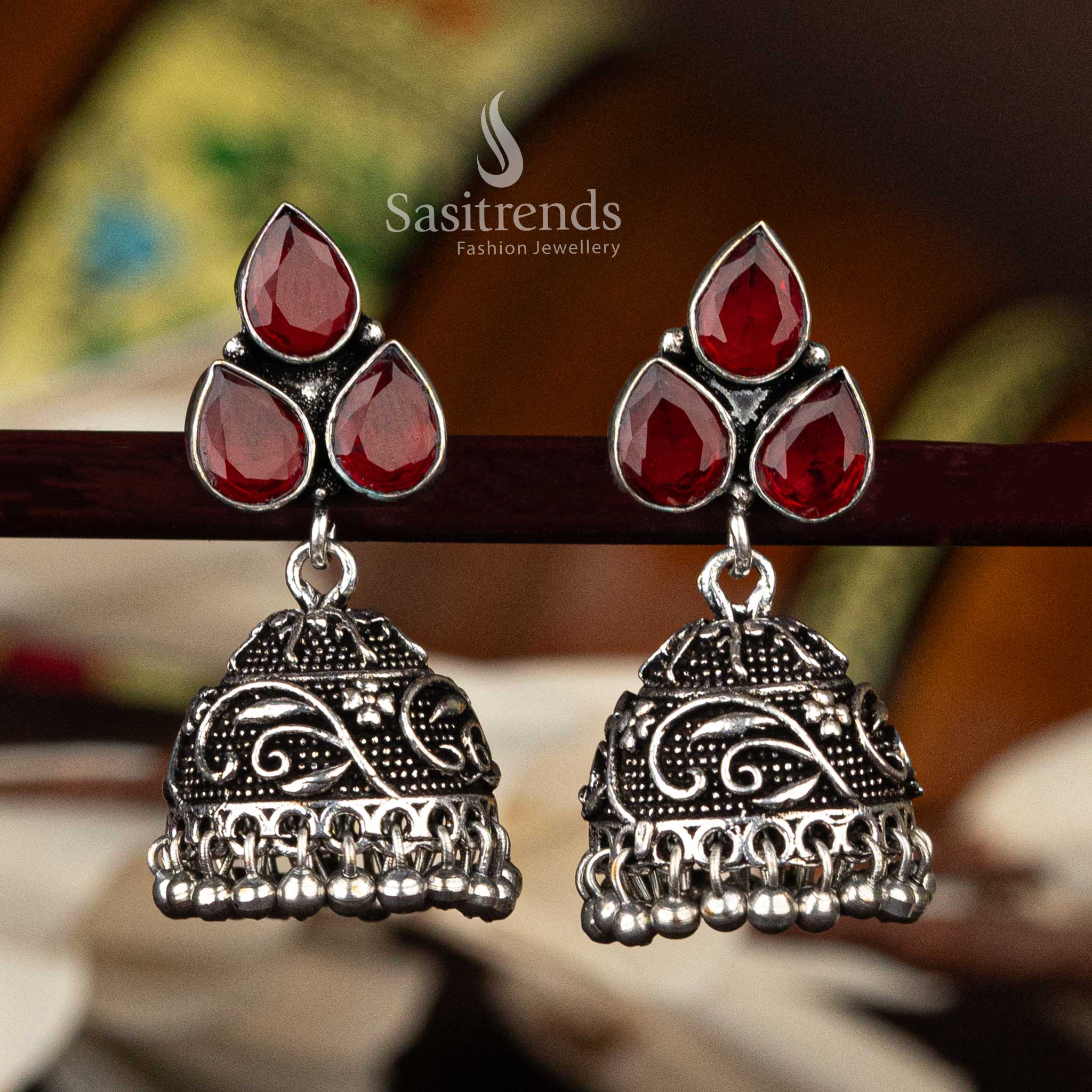 Red waterdrop stone oxidised floral jhumka earrings with intricate design and bead tassels - Sasitrends