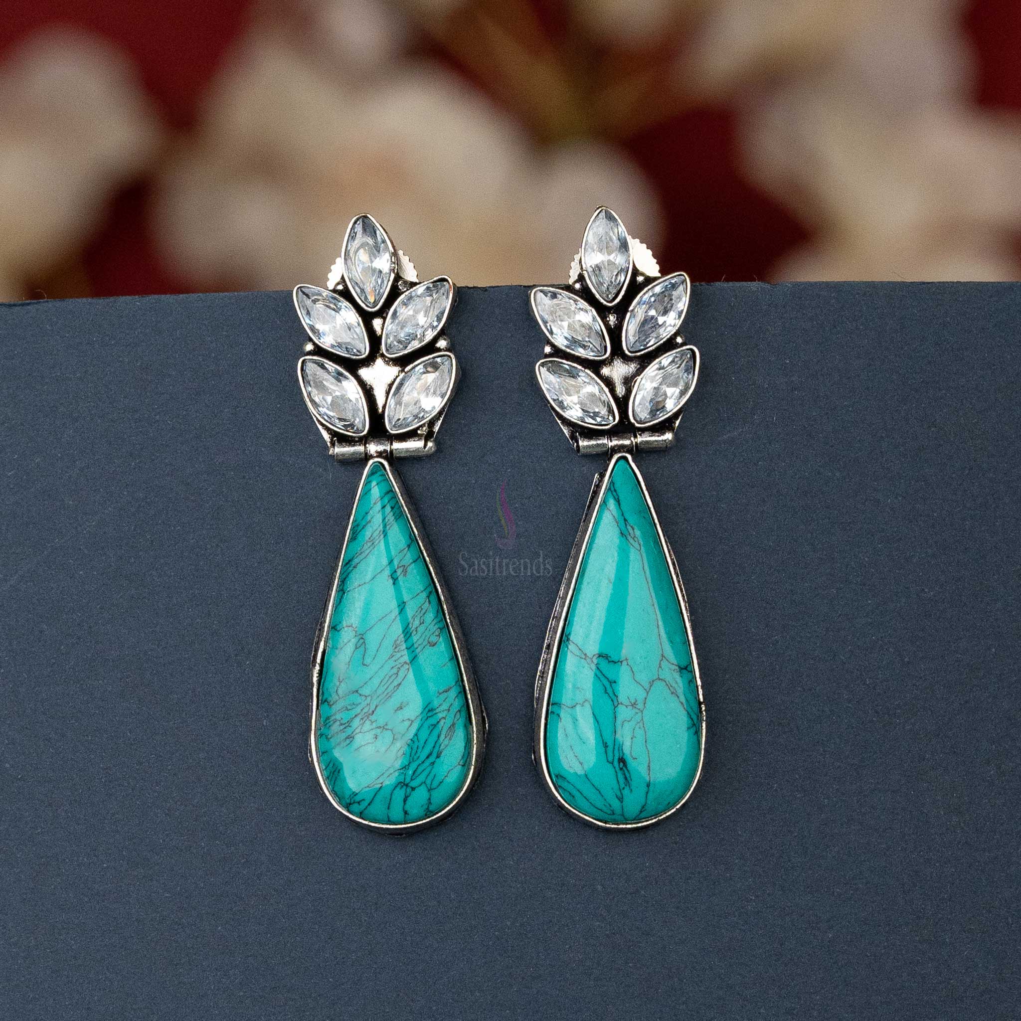 Chic oxidised silver earrings with Turquoise cabochon stone and AD stones, perfect for casual outings.