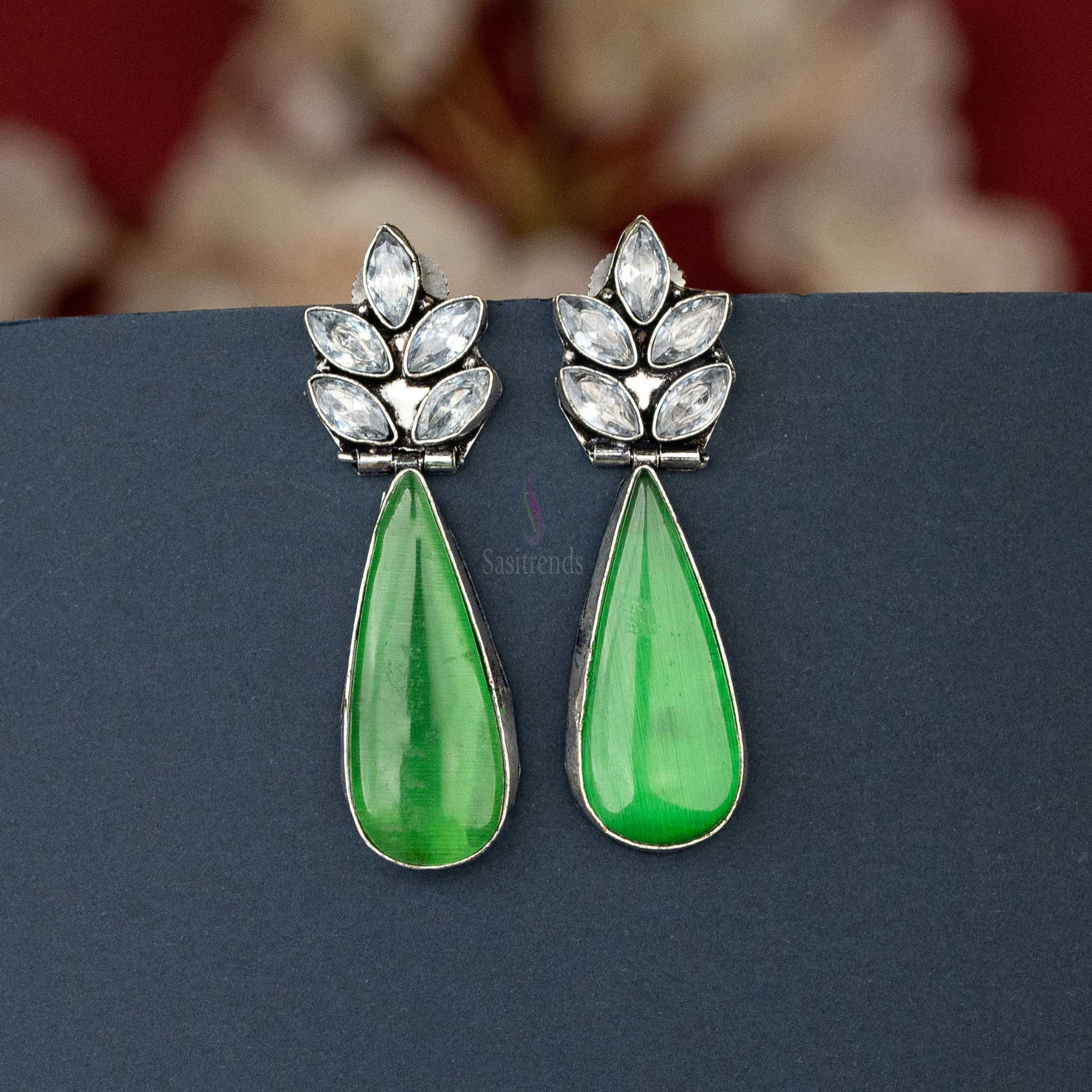 Chic oxidised silver earrings with Green cabochon stone and AD stones, perfect for casual outings.