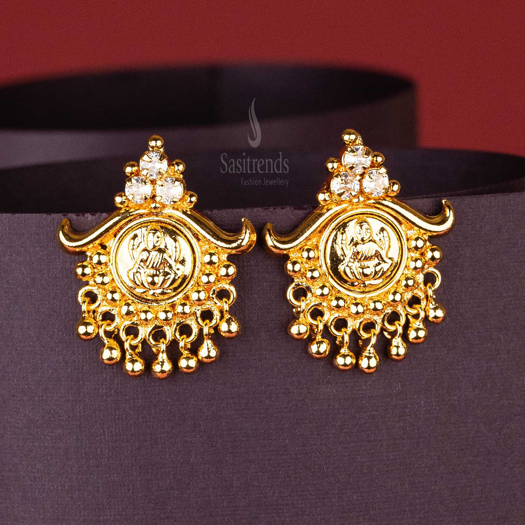 White Traditional Earrings with Lakshmi Motif, Three AD Stones, and Hanging Golden Balls – Authentic Gold-Plated Design