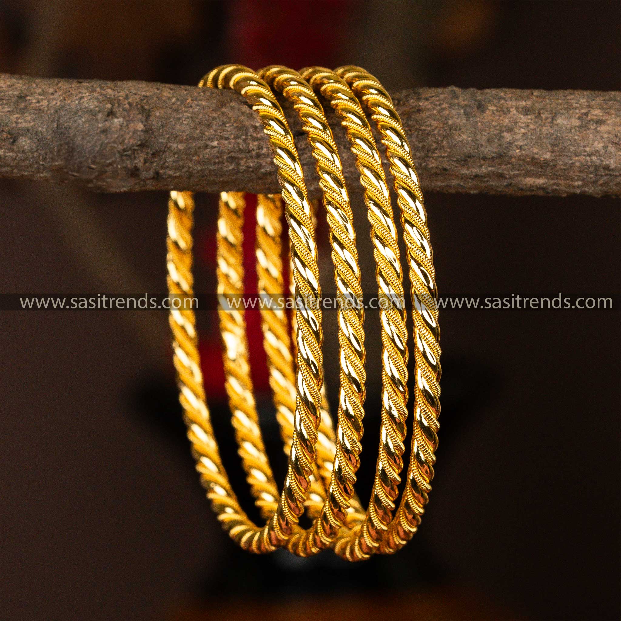 Set of four micro gold-plated kada bangles with an elegant spiral design