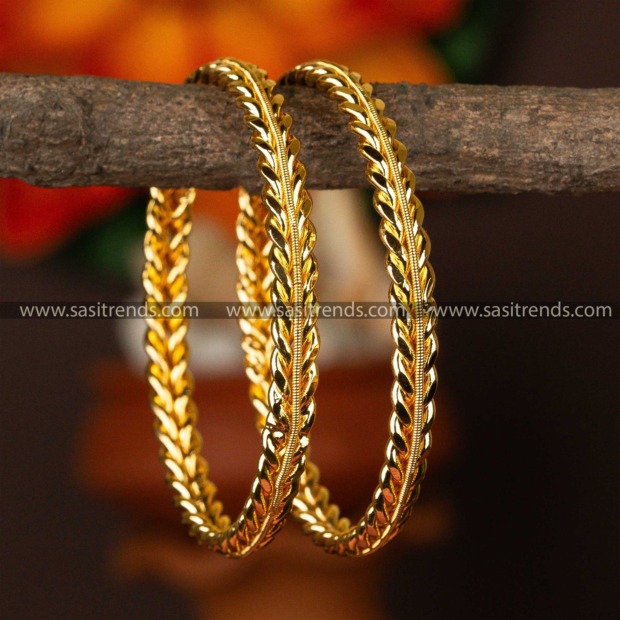 Shimmering micro gold-plated bangles on a rustic backdrop, exemplifying classic style.