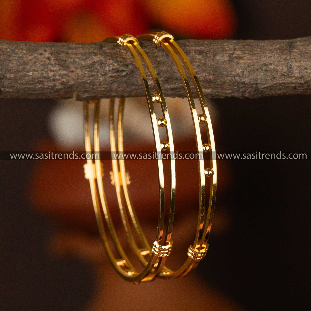 Polished micro gold-plated bangles adorned with evenly spaced golden orbs