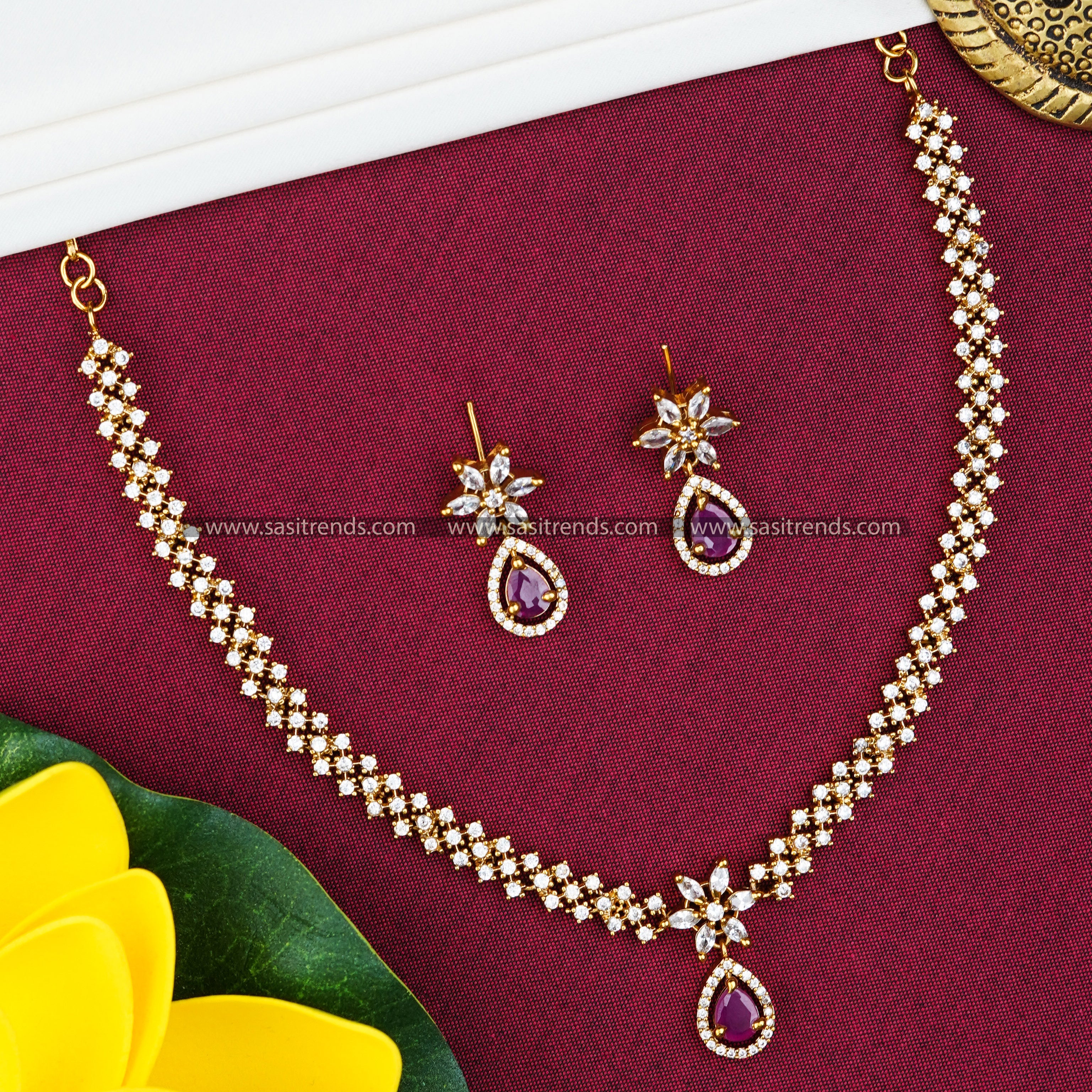 Party wear necklace set with ruby-colored tilak-shaped stone pendant, adorned with American diamond accents