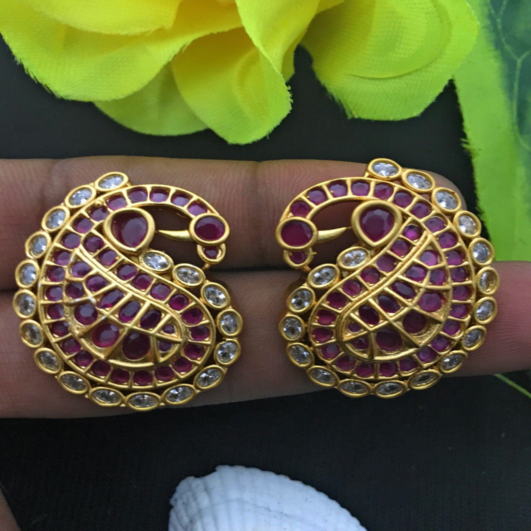 Close-up of Gold Kemp Peacock Stud Earrings: Intricate Detailing and Sparkling Kemp Stones