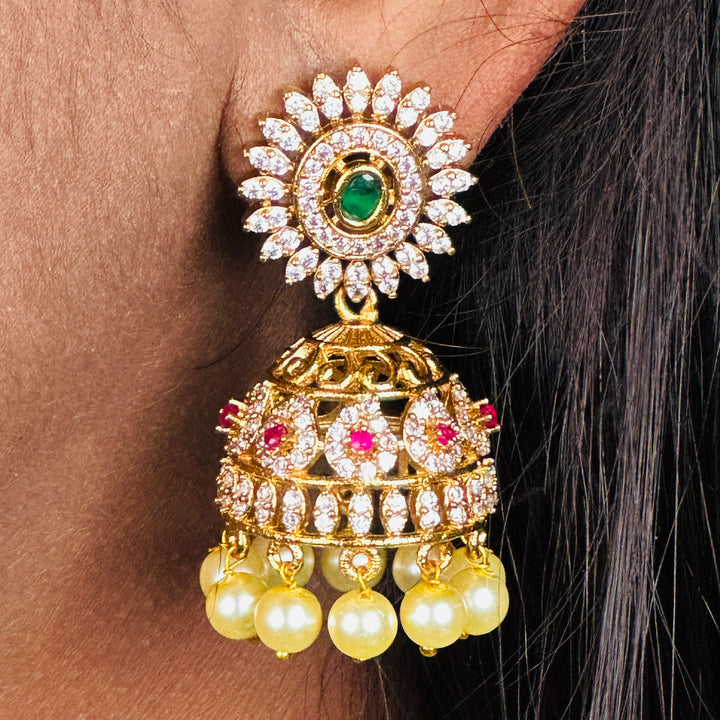 Glamorous Charms Temple Matte Gold Finish AD Stone and Pearl Hangings Jhumka Earrings | Sasitrends