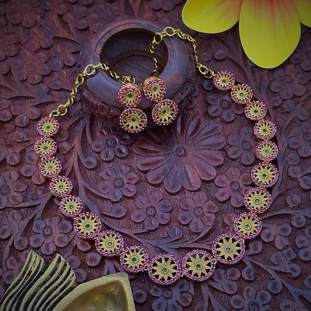 Close-up of Leaf Chakara Pattern Necklace Set: Emerald Green Stone Center Encircled by Ruby Stones, Brass Material with Matte Gold Finish