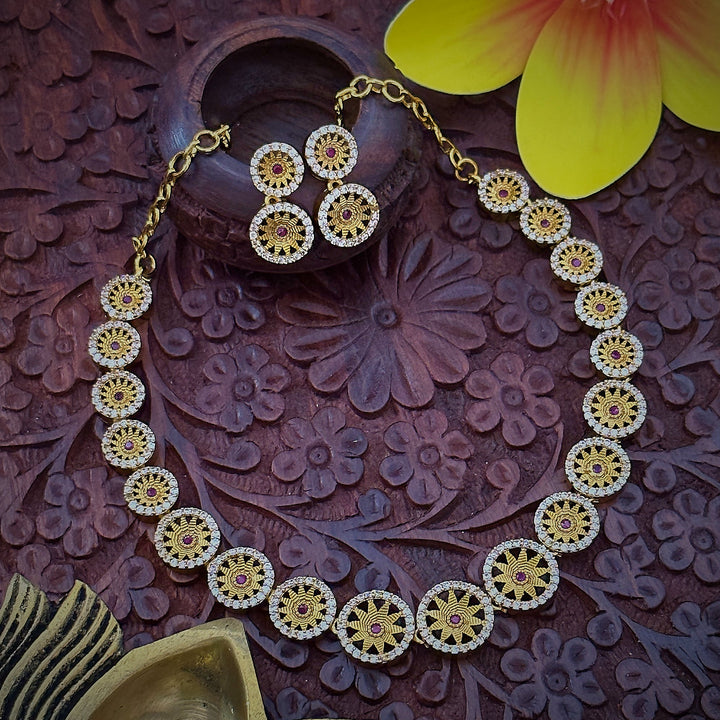 Close-up of Leaf Chakara Pattern Necklace Set: Ruby Stone Center Encircled by White Stones, Brass Material with Matte Gold Finish