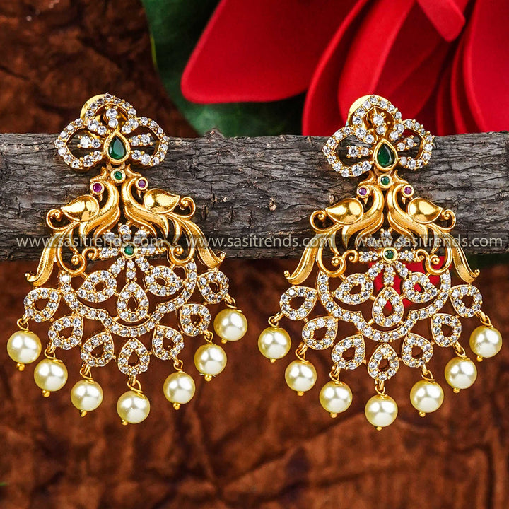 Exquisite Temple Matte Gold Plated Peacock Earrings with AD Stones and Hanging Pearls