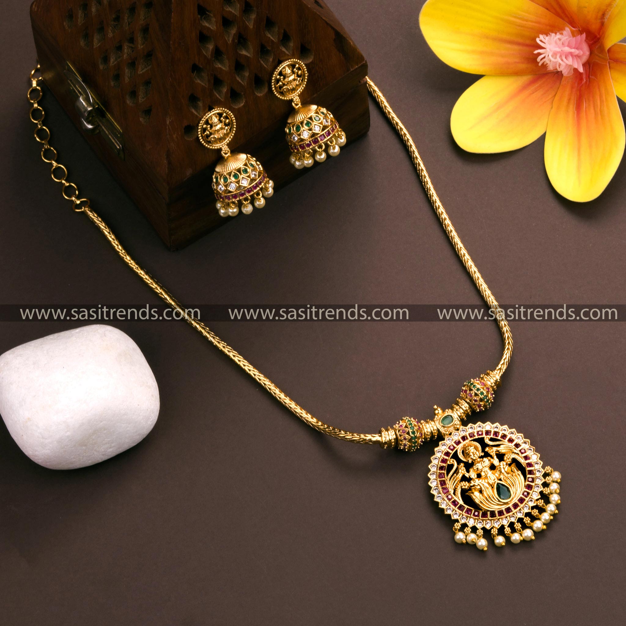 Matte gold plated Lakshmi pendant necklace with jhumkas, adorned with AD stones and pearl drops - Traditional Indian jewelry for women.