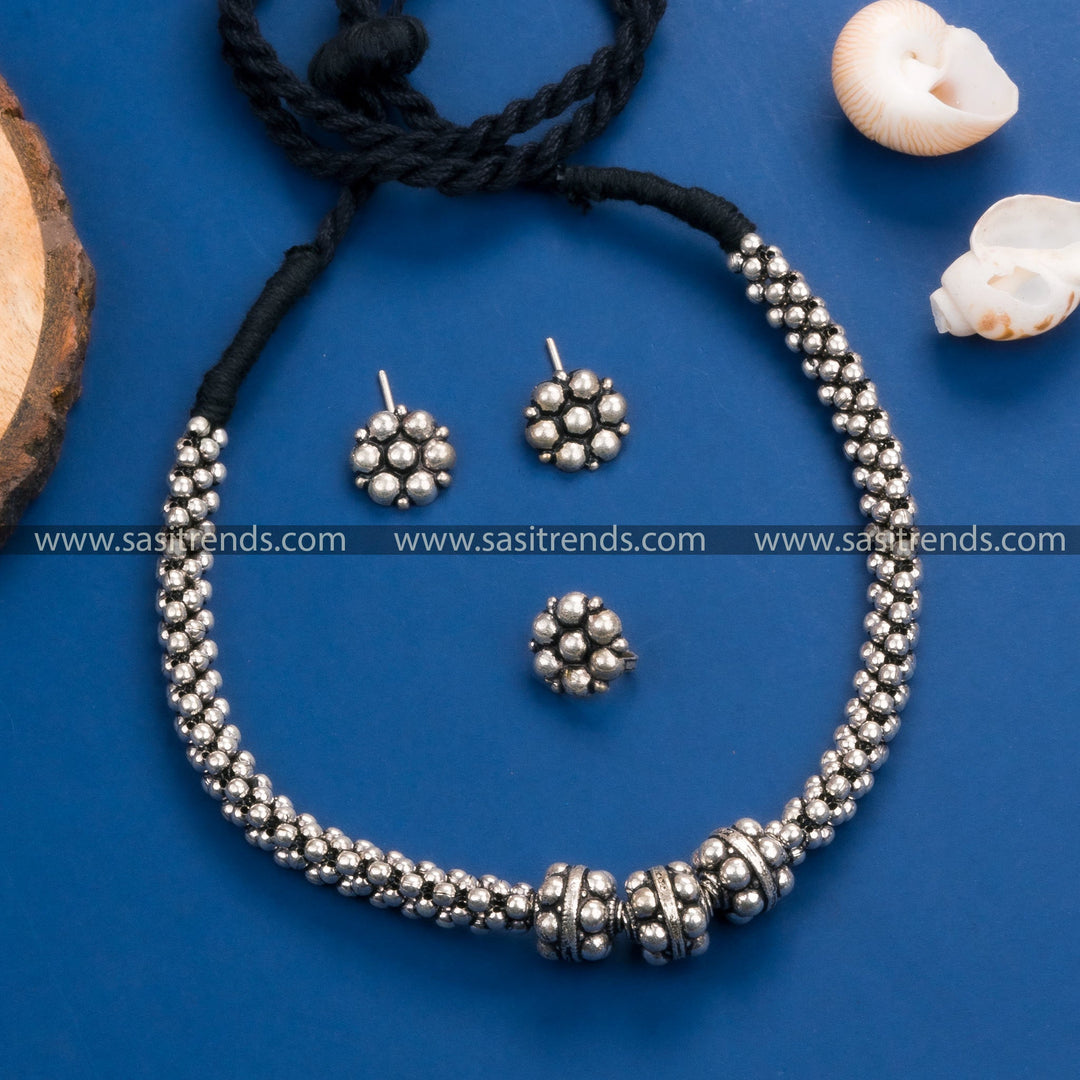 Gorgeous Kolhapuri oxidized silver necklace set with floral earrings and ring, perfect for weddings and festivals.