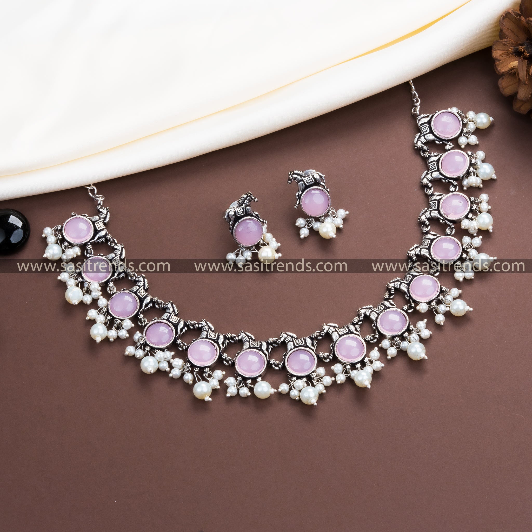 Stunning Pink Stone Accents on Trendy Party Wear Oxidised German Silver Horse Necklace with Pearl Earrings.