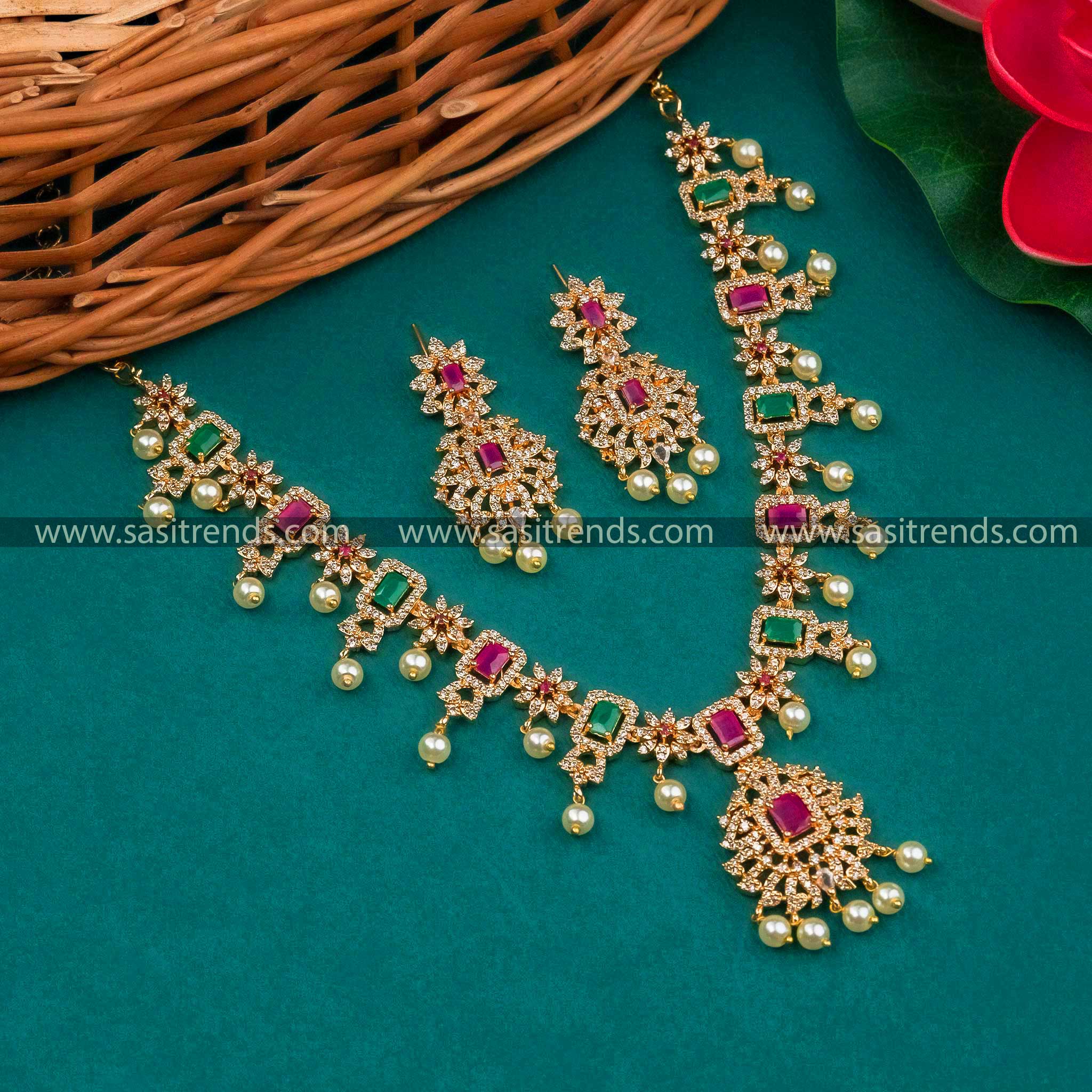 Trendy gold plated flower pendant necklace & Earrings with AD stones and pearl drops.