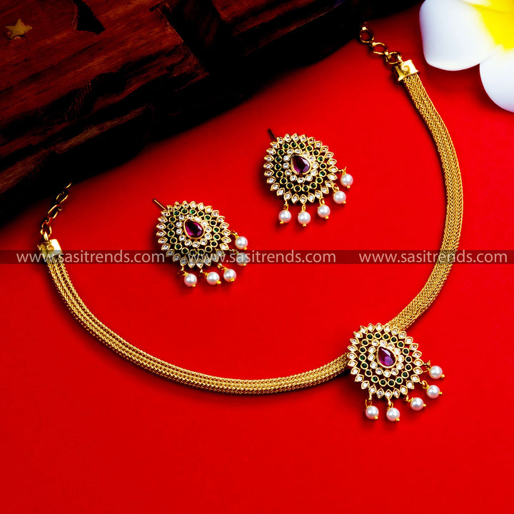 Traditional choker with temple gold plating, floral pendant, and pearl drops. Perfect for weddings and festivals.