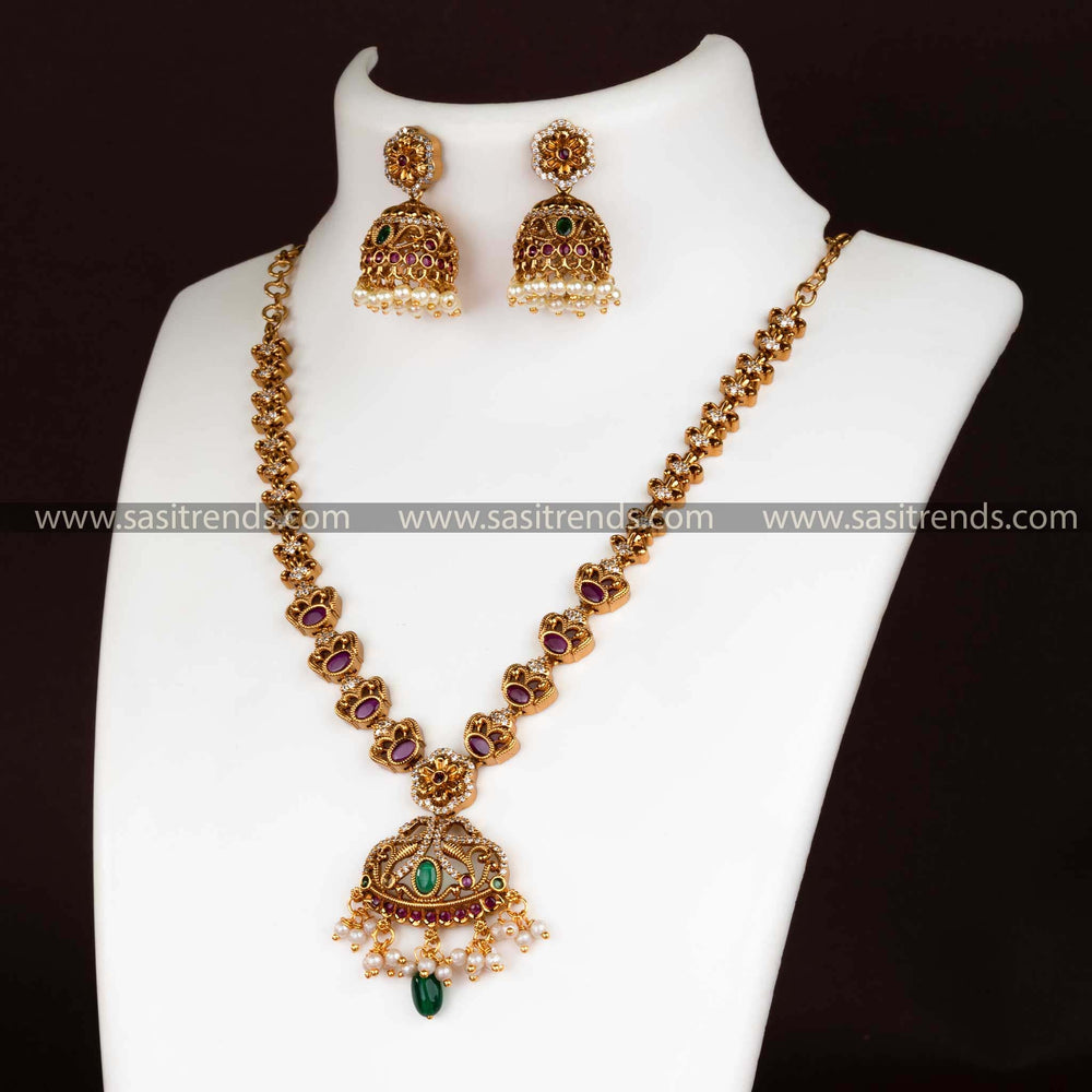 Matte gold floral pendant necklace set with AD stones and pearl jhumkas for women.